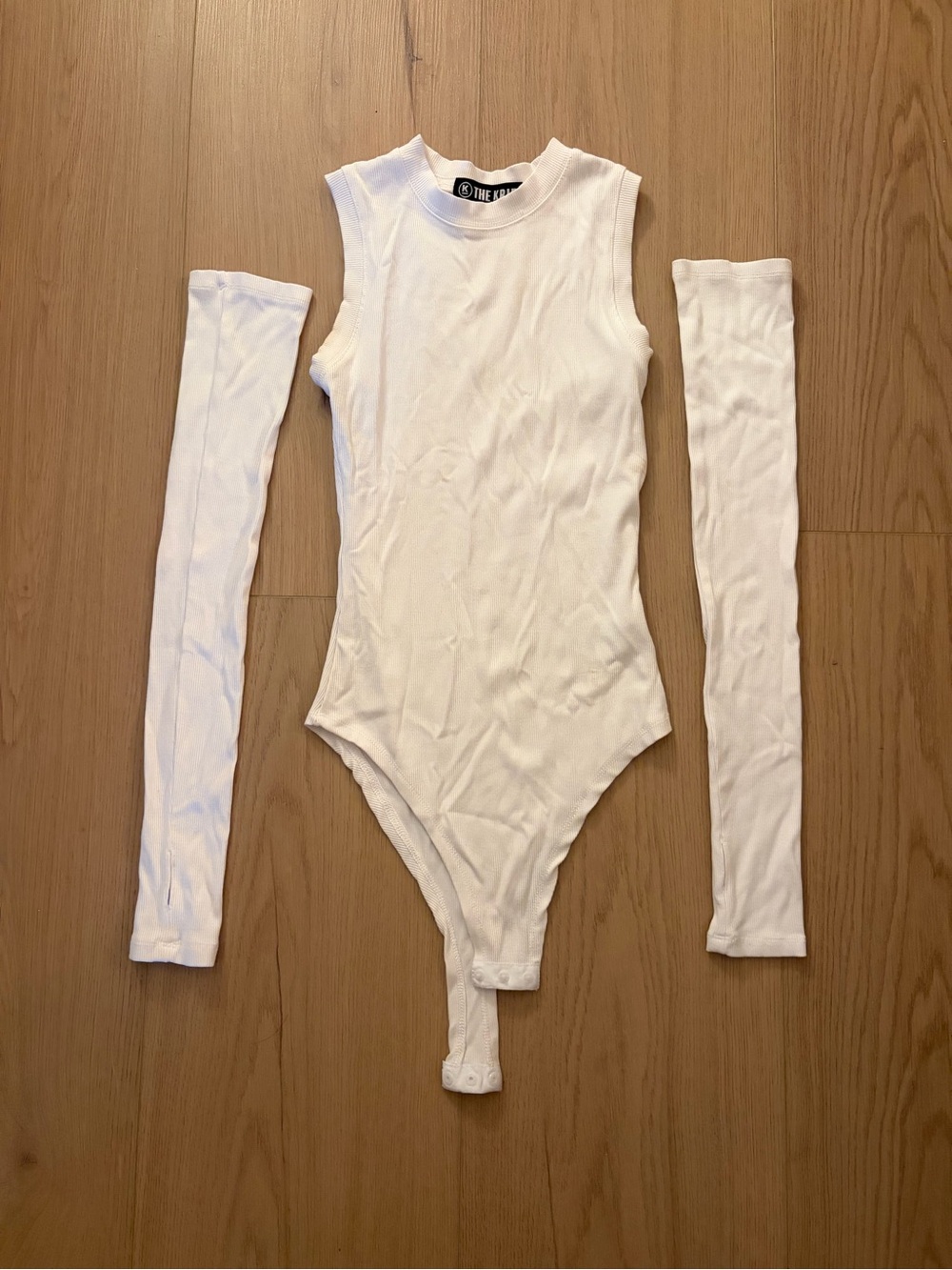 The Pangaea White Ribbed Sleeveless Bodysuit with Detachable Arm Sleeves